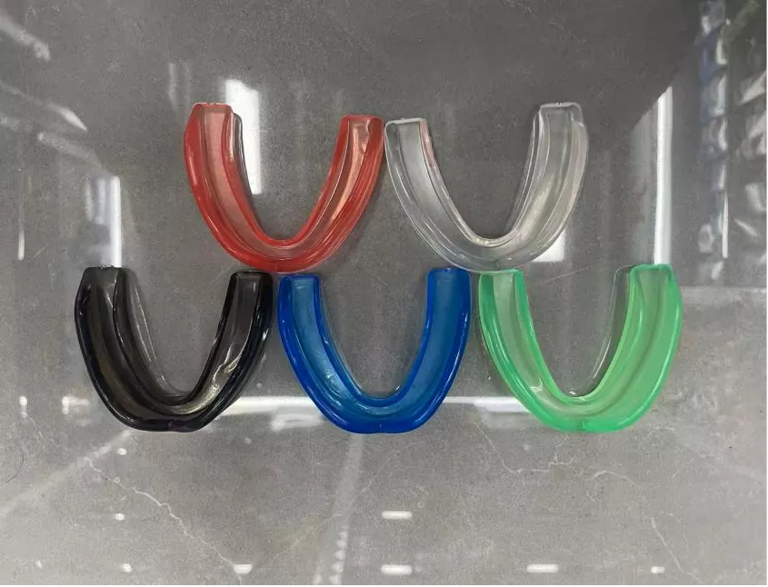 Collection of youth mouthguards in various colors and sizes manufactured by Pandawin Sports